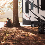 2019 KZ RV Venom V3911TK Fifth Wheel Toy Hauler with Couple at Campsite