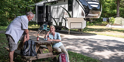 2020 KZ RV Durango D333RLT Fifth Wheel with couple at campsite