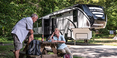 2020 KZ RV Durango D333RLT Fifth Wheel with couple at campsite