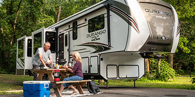 2020 KZ RV Durango Gold G391RKQ Fifth Wheel with couple at campsite