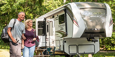 2020 KZ RV Durango Gold G391RKQ Fifth Wheel with couple at campsite