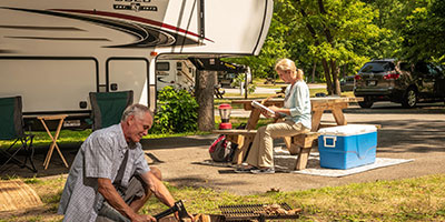 2020 KZ RV Durango Gold G391RKQ Fifth Wheel with couple at campsite