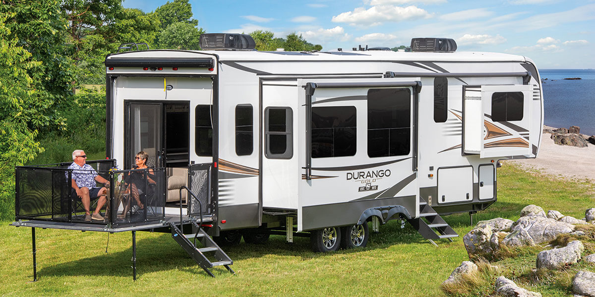 2022 KZ RV Durango Gold G358RPQ Fifth Wheel with Couple on Exterior Patio