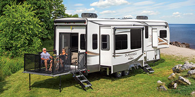 2022 KZ RV Durango Gold G358RPQ Fifth Wheel with Couple at Beach Campsite