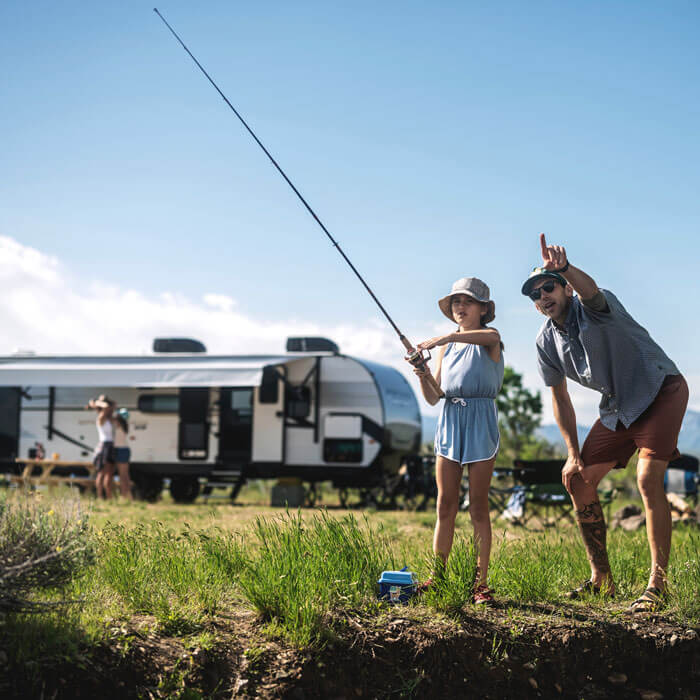 KZ RV Sportsmen SE Travel Trailer at Campground with Family Fishing